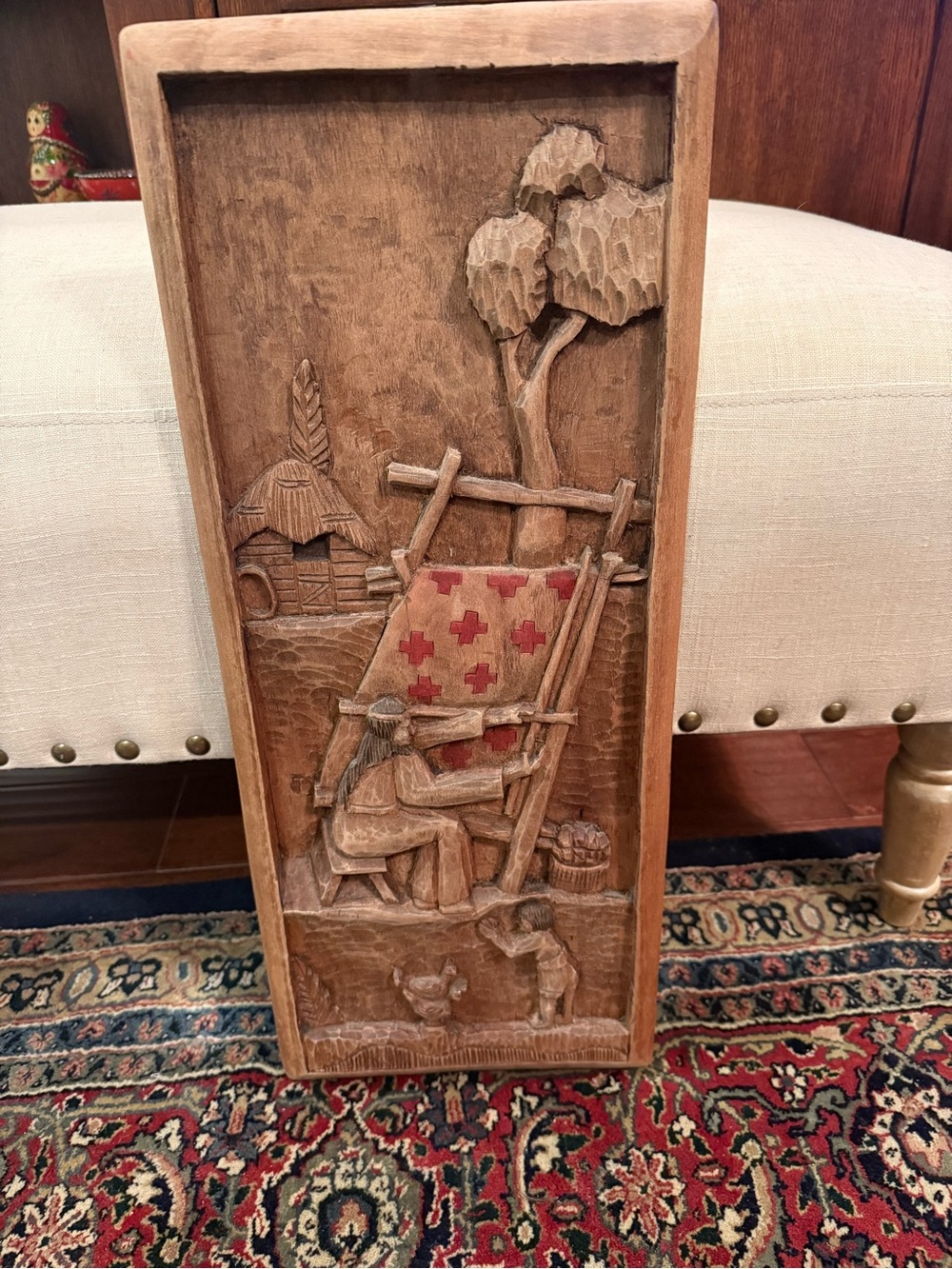 Carved Wood Panel with Red Cross-Stitched Quilt Motif.